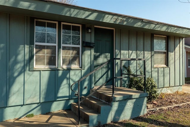 property entrance featuring board and batten siding