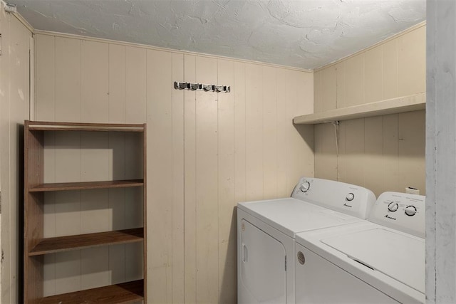 clothes washing area with laundry area, independent washer and dryer, and a textured ceiling