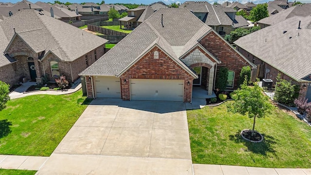 1412 Reid Pryor Rd, Norman, OK 73072 - view of front of property with brick siding, a residential view, a garage, driveway, and a front lawn