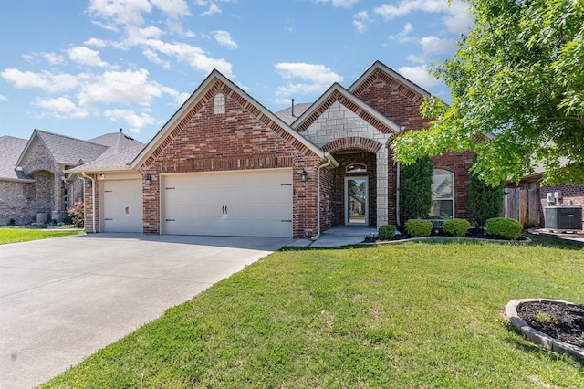 1412 Reid Pryor Rd, Norman, OK 73072 - view of front facade featuring an attached garage, central AC, brick siding, a front lawn, and driveway