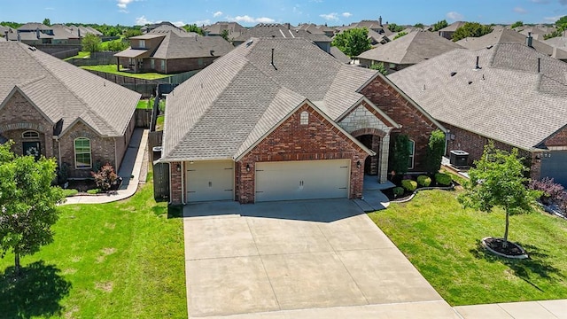1412 Reid Pryor Rd, Norman, OK 73072 - view of front of property with brick siding, a garage, driveway, a residential view, and a front yard