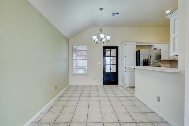 interior space with visible vents, a notable chandelier, light tile patterned floors, baseboards, and vaulted ceiling