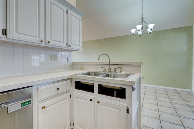 kitchen featuring dishwasher, light countertops, decorative backsplash, a peninsula, and a sink