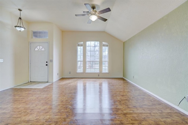 entryway with wood finished floors, baseboards, visible vents, ceiling fan, and vaulted ceiling