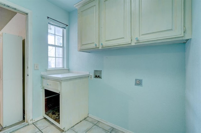 laundry room featuring electric dryer hookup, cabinet space, hookup for a washing machine, and light tile patterned floors