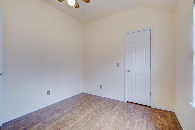 unfurnished room with baseboards, wood finished floors, a ceiling fan, and vaulted ceiling