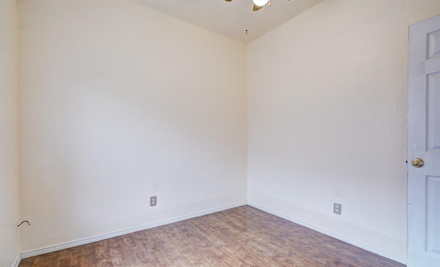 unfurnished room featuring a ceiling fan, baseboards, and wood finished floors