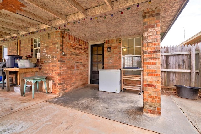 view of patio / terrace featuring fence