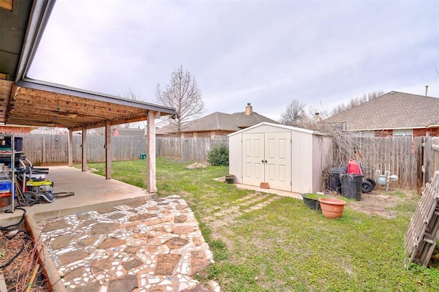 view of yard featuring an outdoor structure, a storage unit, a patio area, and a fenced backyard