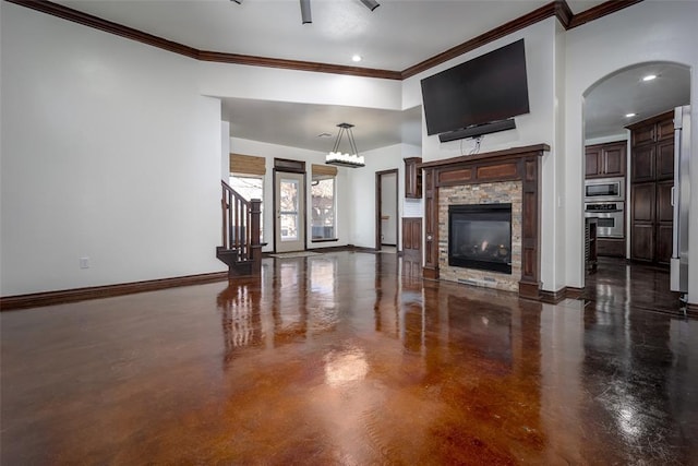 3520 SW 123rd Pl, Oklahoma City, OK 73170 - living area with arched walkways, a stone fireplace, baseboards, stairs, and crown molding