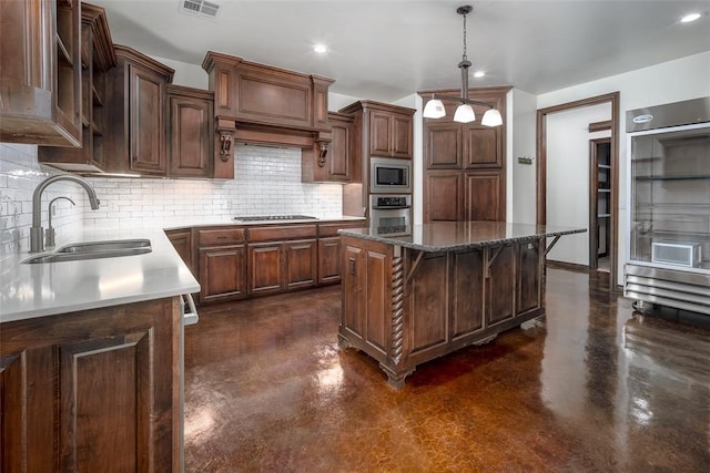 3520 SW 123rd Pl, Oklahoma City, OK 73170 - kitchen featuring a kitchen island, appliances with stainless steel finishes, concrete flooring, and a sink