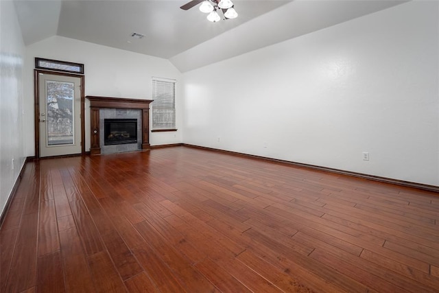 3520 SW 123rd Pl, Oklahoma City, OK 73170 - unfurnished living room featuring dark wood-type flooring, lofted ceiling, ceiling fan, and a tiled fireplace