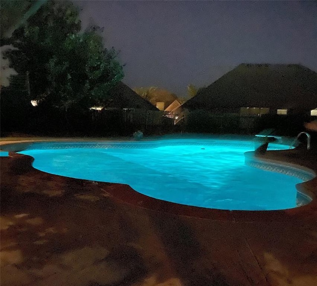 3520 SW 123rd Pl, Oklahoma City, OK 73170 - pool at night featuring an outdoor pool