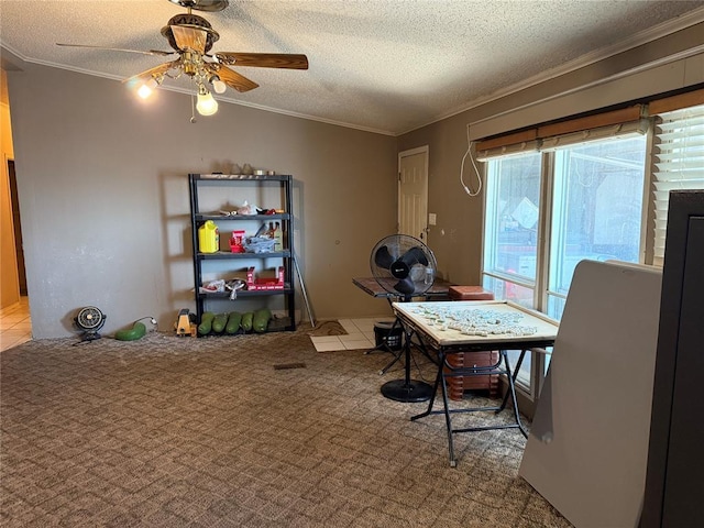 rec room with ornamental molding, carpet, a textured ceiling, and a ceiling fan