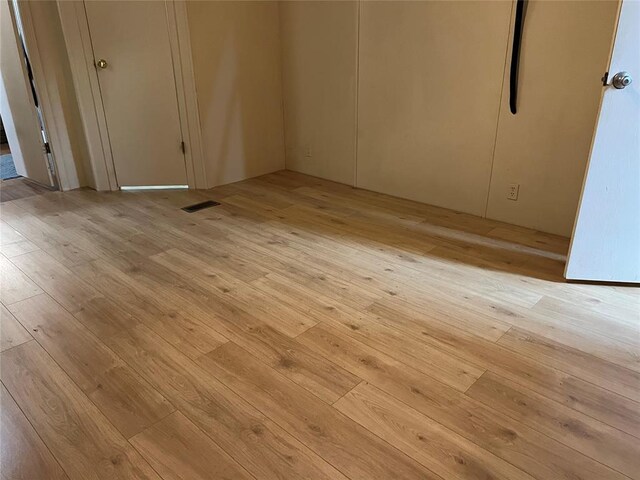 unfurnished bedroom featuring light wood finished floors and visible vents