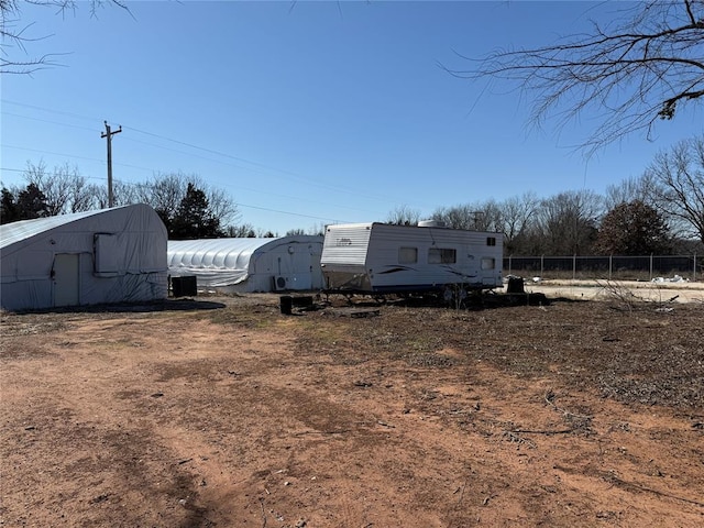 view of yard featuring an outbuilding and fence