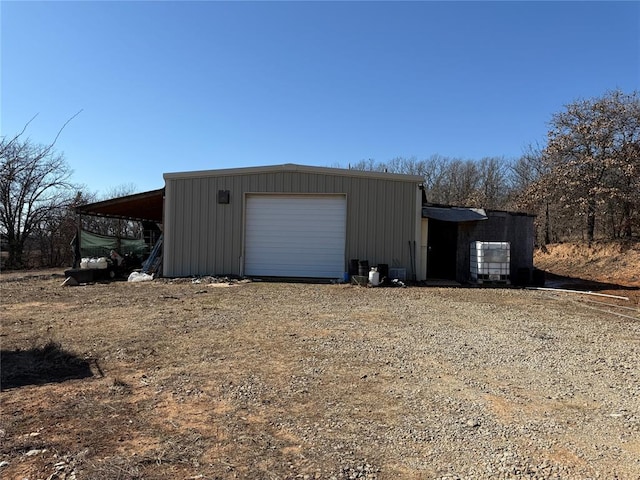 detached garage with dirt driveway