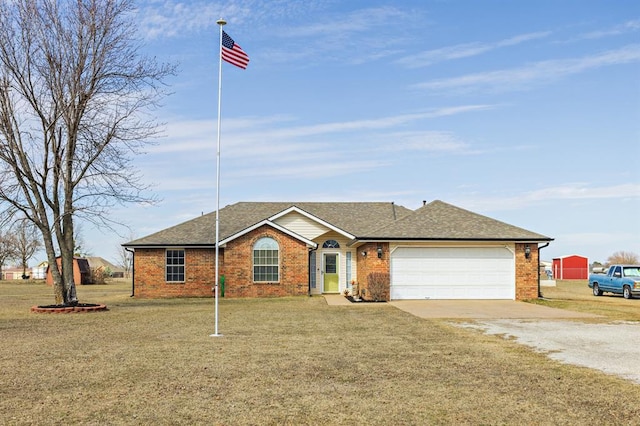 ranch-style home with driveway, a garage, a front lawn, and brick siding