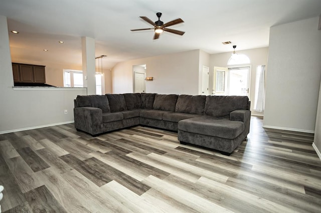 living area featuring recessed lighting, visible vents, baseboards, and wood finished floors