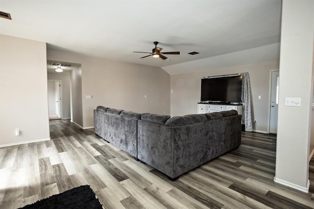 living room featuring visible vents, baseboards, and wood finished floors