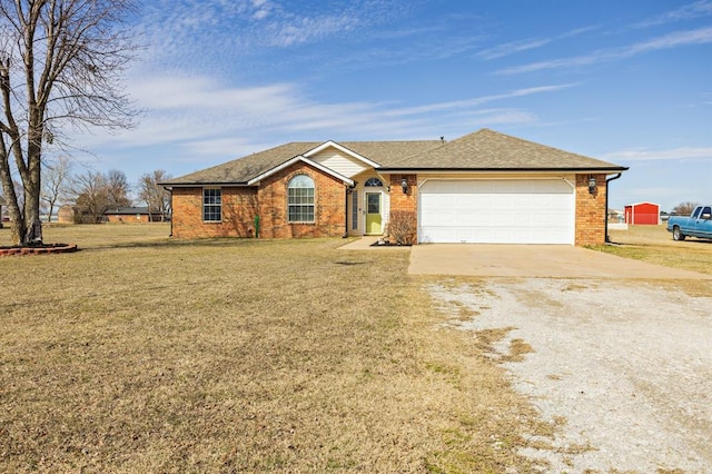 single story home featuring concrete driveway, roof with shingles, an attached garage, a front lawn, and brick siding