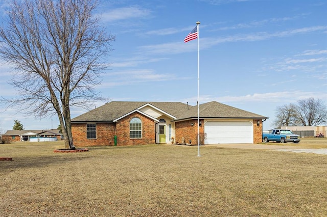 ranch-style house with an attached garage, brick siding, concrete driveway, and a front yard