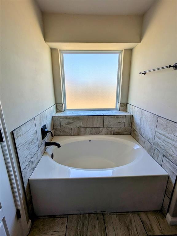 2402 Cattail Cir, Midwest City, OK 73130 - bathroom featuring a garden tub and wainscoting