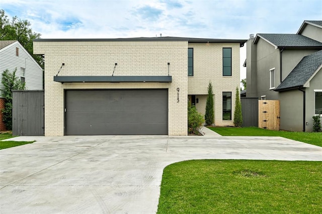 multi unit property featuring a front yard, a gate, brick siding, and concrete driveway