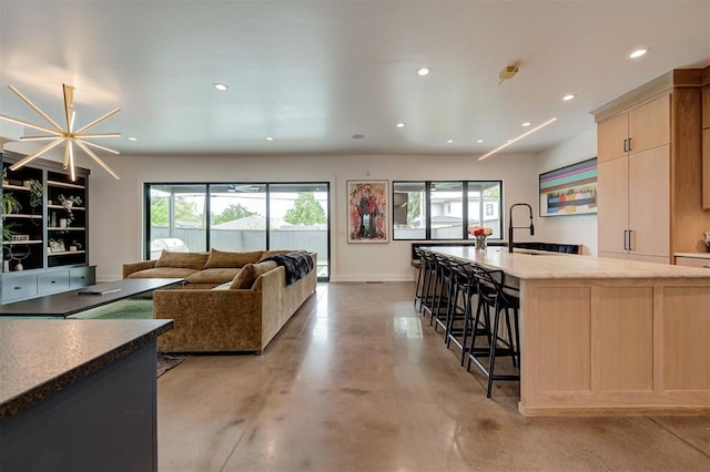 interior space featuring finished concrete floors, recessed lighting, and baseboards