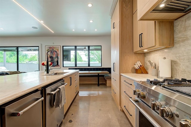 kitchen featuring premium range hood, light brown cabinets, appliances with stainless steel finishes, and backsplash