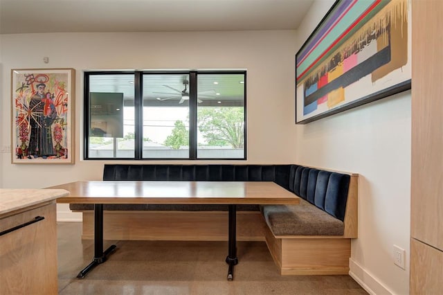 dining space featuring breakfast area and baseboards