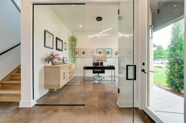 interior space with finished concrete floors and baseboards