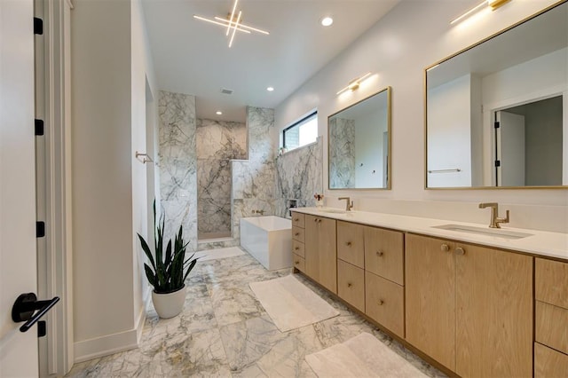 full bath featuring marble finish floor, walk in shower, a sink, and a tub