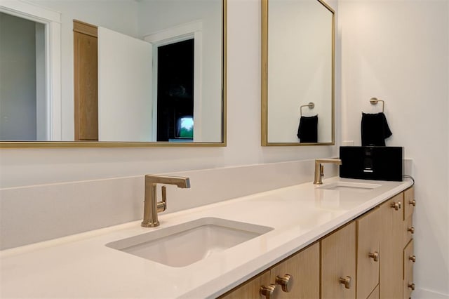 bathroom featuring a sink and double vanity