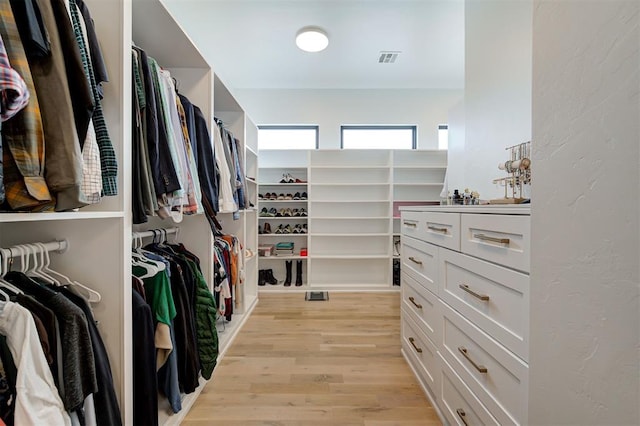 spacious closet featuring light wood-type flooring and visible vents