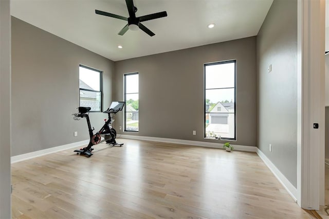 workout room featuring recessed lighting, ceiling fan, light wood-style flooring, and baseboards