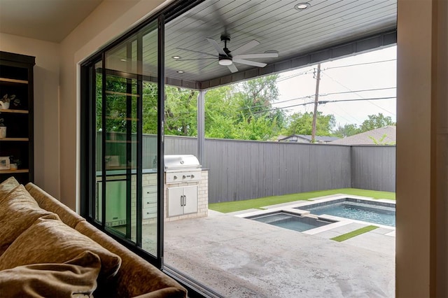 exterior space featuring a patio, ceiling fan, grilling area, an in ground hot tub, and fence