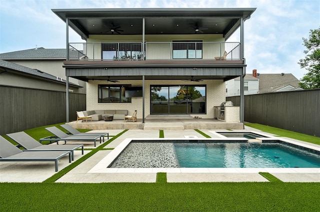 back of house with a balcony, a patio area, a fenced backyard, and an outdoor hangout area