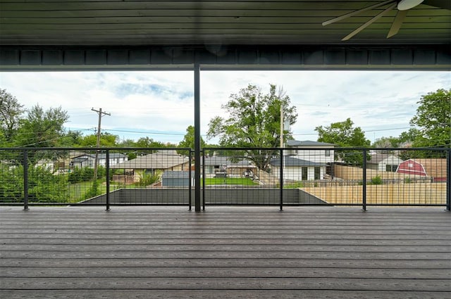 deck with ceiling fan and fence