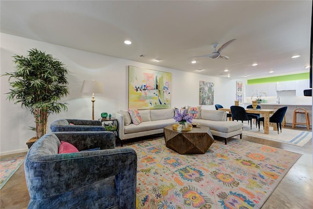 living room with ceiling fan, baseboards, and recessed lighting