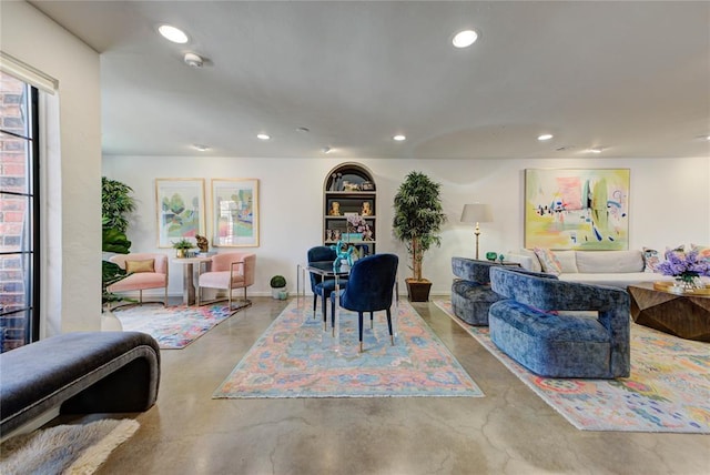 interior space featuring concrete flooring, recessed lighting, and baseboards