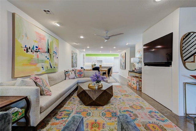 living room with ceiling fan, visible vents, and recessed lighting