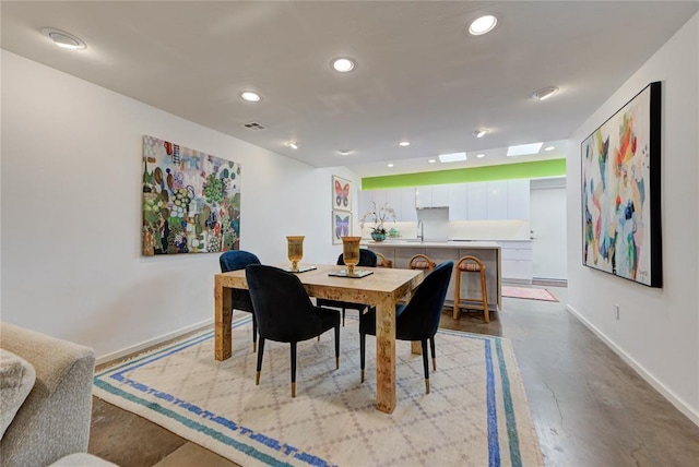 dining space with baseboards, concrete flooring, visible vents, and recessed lighting