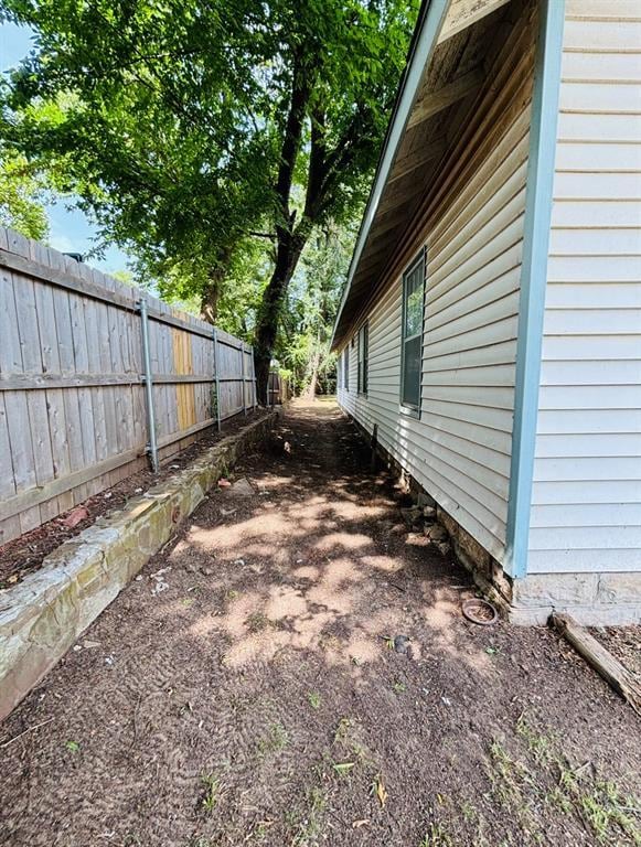 view of side of property with fence