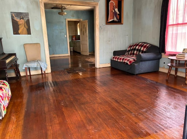 sitting room with wood-type flooring