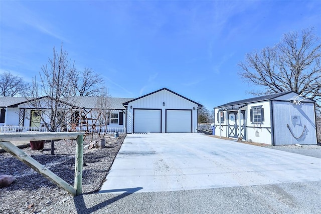 exterior space with an outbuilding, driveway, a shed, and an attached garage