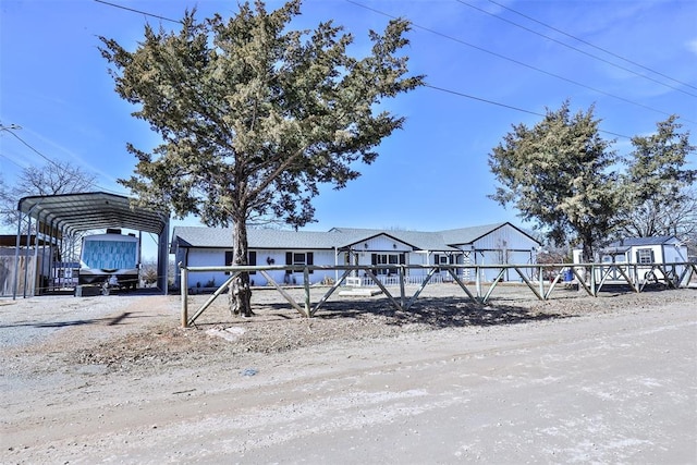 view of front of property featuring a carport