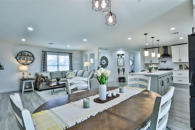 dining space with recessed lighting, visible vents, baseboards, and wood finished floors