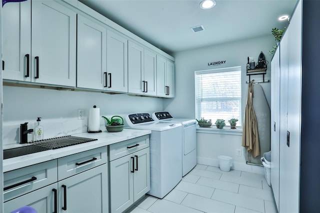 laundry area featuring washer and clothes dryer, recessed lighting, visible vents, cabinet space, and baseboards