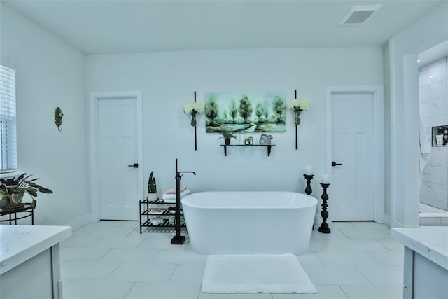 bathroom featuring visible vents, vanity, a freestanding bath, baseboards, and a marble finish shower